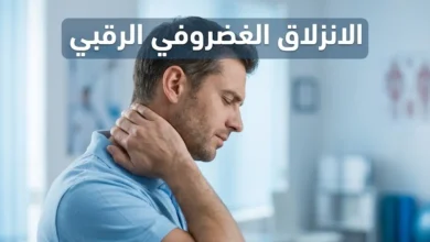 رجل في أواخر الثلاثينيات يمسك رقبته من الجانب الأيسر بتعبير ألم خفيف داخل عيادة علاج طبيعي حديثة مع عنوان الانزلاق الغضروفي الرقبي