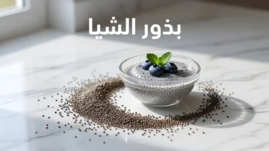 بذور الشيا مع بودينغ الشيا المنقوع في وعاء زجاجي على سطح رخامي أبيض مع التوت الأزرق وأوراق النعناع